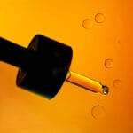 A drop of natural antioxidant oil serum on skin