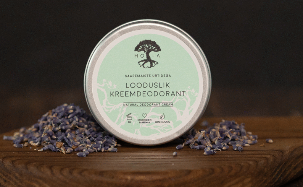 Cream deodorant with Saaremaa herbs in glass jar on wooden background