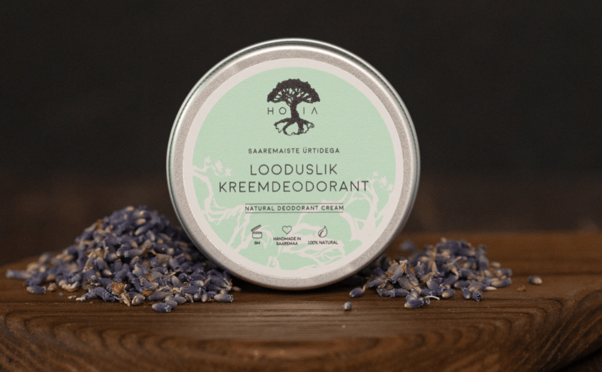 Cream deodorant with Saaremaa herbs in glass jar on wooden background